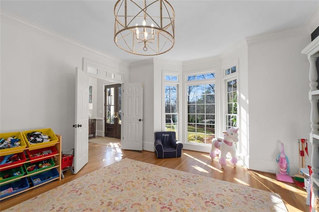 310 Glen Hampton Place Alpharetta, GA 30004 - Photo 48 of 61 a living room with furniture gym equipment and a chandelier