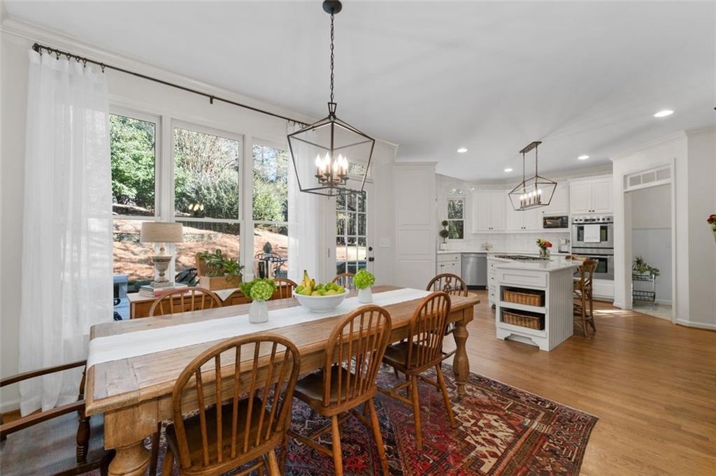 310 Glen Hampton Place Alpharetta, GA 30004 - Photo 50 of 61 a view of a dining room with furniture window and wooden floor