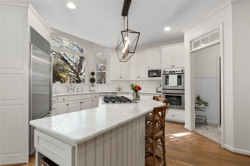310 Glen Hampton Place Alpharetta, GA 30004 - Photo 51 of 61 a kitchen with a sink a counter space appliances and cabinets