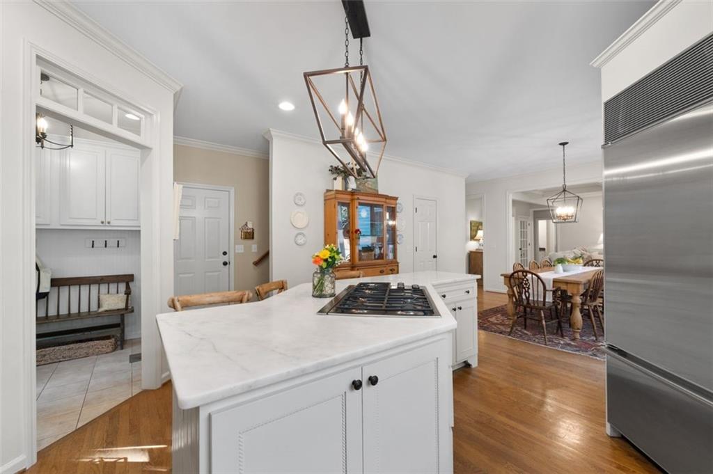 310 Glen Hampton Place Alpharetta, GA 30004 - Photo 52 of 61 a kitchen with a table chairs refrigerator and cabinets