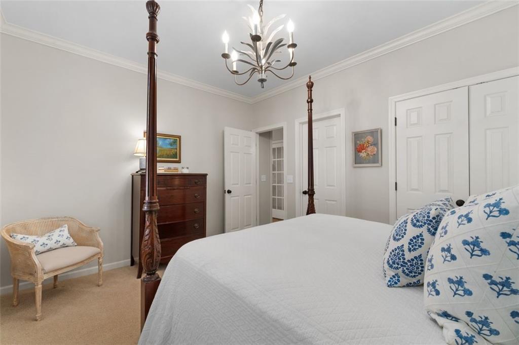 310 Glen Hampton Place Alpharetta, GA 30004 - Photo 54 of 61 a bedroom with a bed and a chandelier