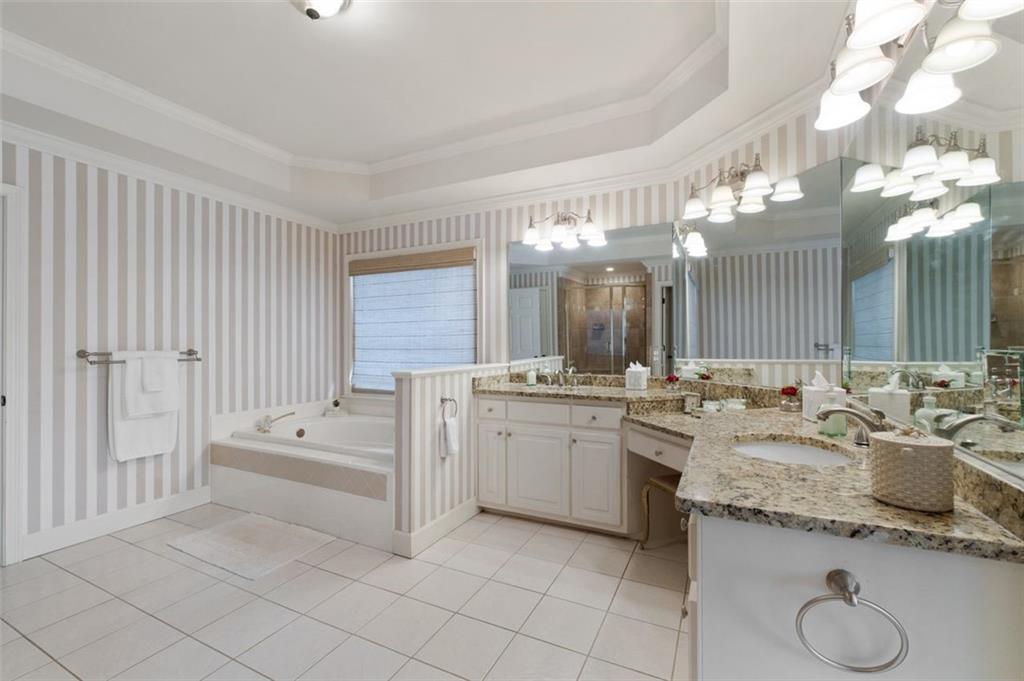310 Glen Hampton Place Alpharetta, GA 30004 - Photo 56 of 61 a bathroom with a granite countertop sink and a mirror