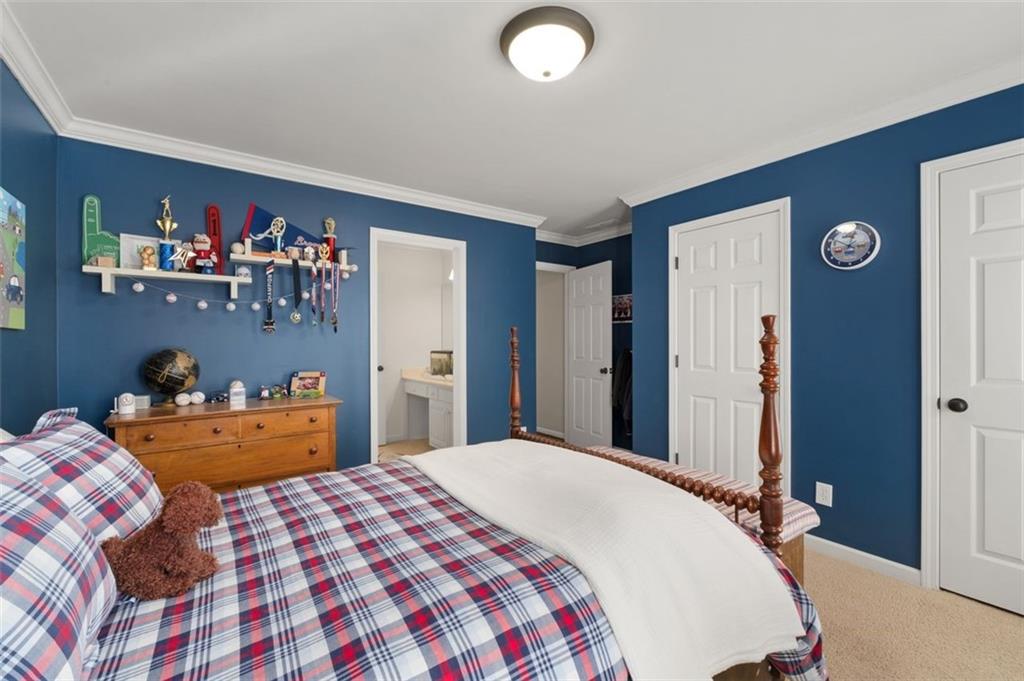 310 Glen Hampton Place Alpharetta, GA 30004 - Photo 57 of 61 a bedroom with a bed and a dresser in it