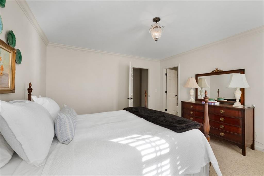 310 Glen Hampton Place Alpharetta, GA 30004 - Photo 59 of 61 a bedroom with a bed and a dresser
