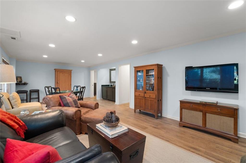 310 Glen Hampton Place Alpharetta, GA 30004 - Photo 60 of 61 a living room with furniture and a flat screen tv