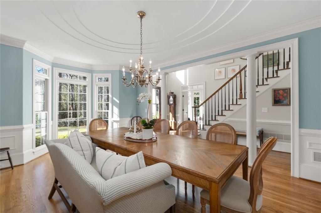 310 Glen Hampton Place Alpharetta, GA 30004 - Photo 8 of 61 a view of a dining room with furniture wooden floor and chandelier