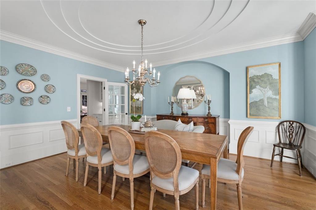 310 Glen Hampton Place Alpharetta, GA 30004 - Photo 9 of 61 a view of a dining room with furniture a chandelier and wooden floor
