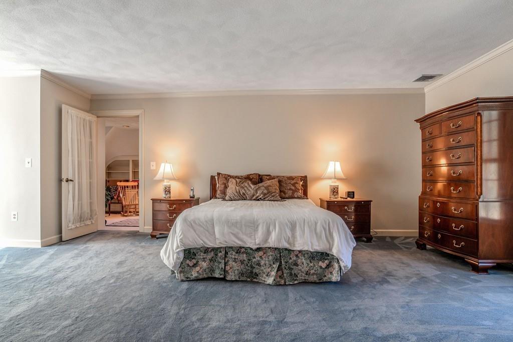 104 Fox Run Road Sudbury, MA 01776 - Photo 22 of 36 a spacious bedroom with a bed and cabinets