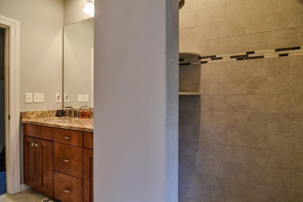 104 Fox Run Road Sudbury, MA 01776 - Photo 27 of 36 a bathroom with a granite countertop sink a toilet and a mirror