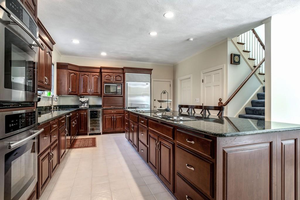 104 Fox Run Road Sudbury, MA 01776 - Photo 6 of 36 a kitchen with granite countertop a sink a counter top space stainless steel appliances and cabinets