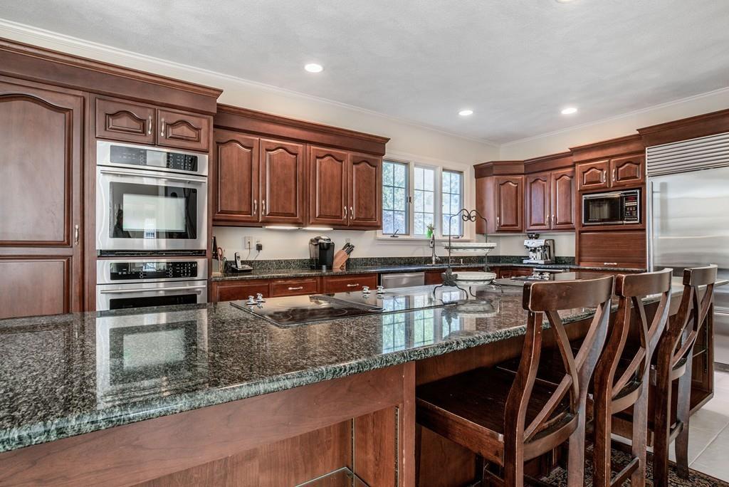104 Fox Run Road Sudbury, MA 01776 - Photo 7 of 36 a kitchen with stainless steel appliances granite countertop a stove top oven a sink and a granite counter tops
