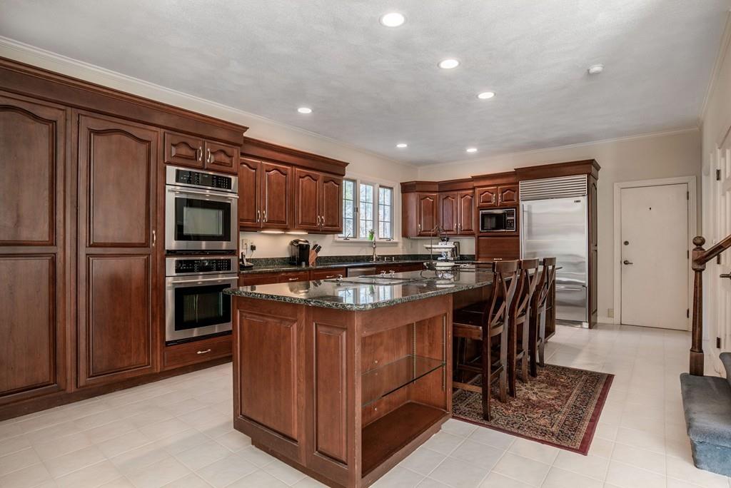 104 Fox Run Road Sudbury, MA 01776 - Photo 9 of 36 a kitchen with kitchen island a counter top space cabinets and stainless steel appliances
