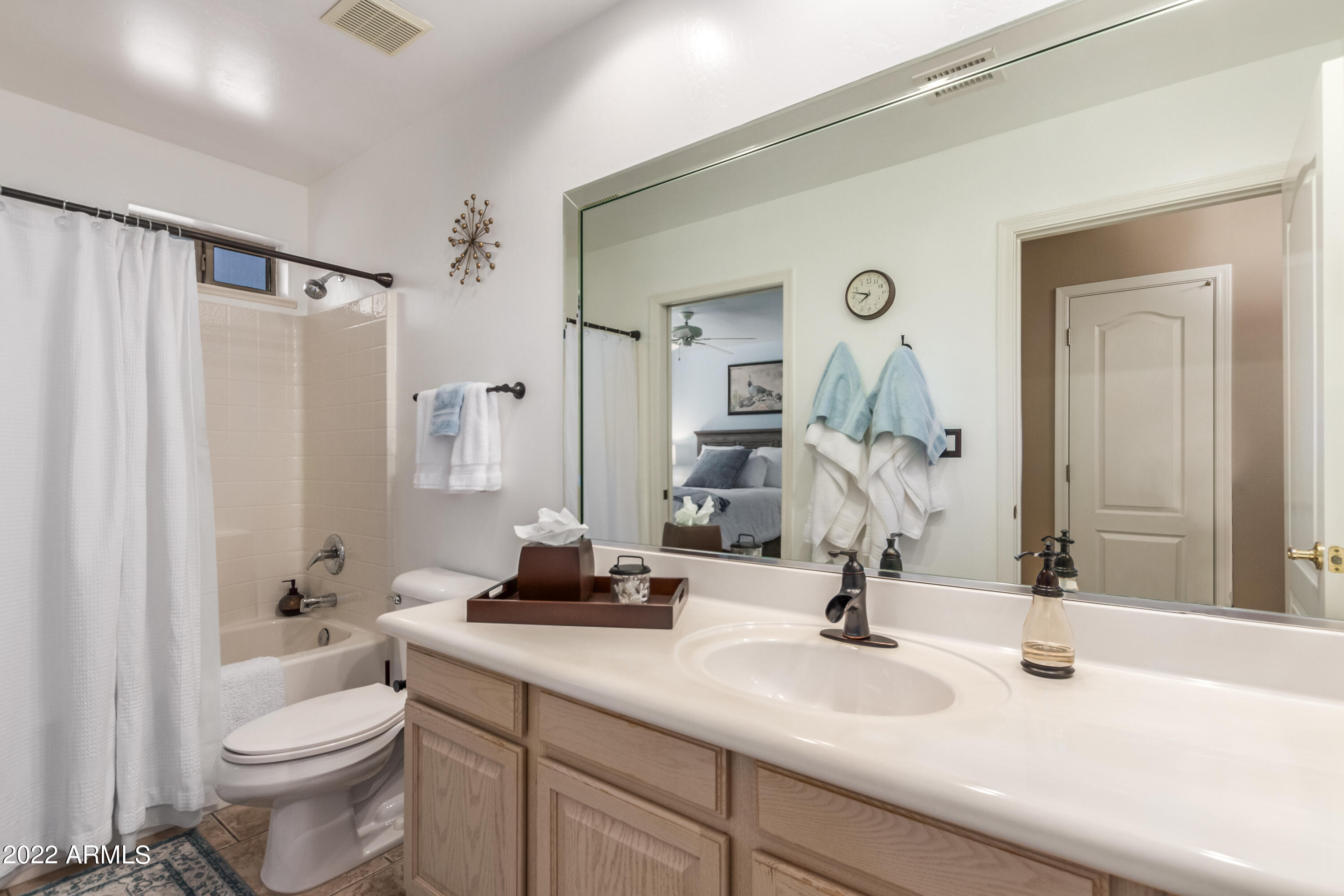 5830 East McKellips Road, Unit 76 Mesa, AZ 85215 - Photo 25 of 33 a bathroom with a sink a toilet and a mirror