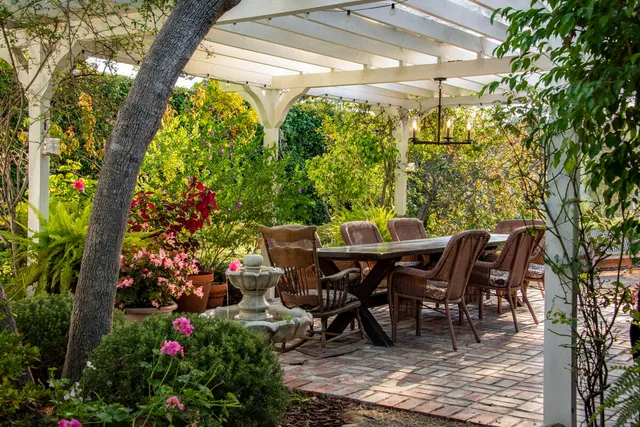 a view of a dining table and chairs in the patio