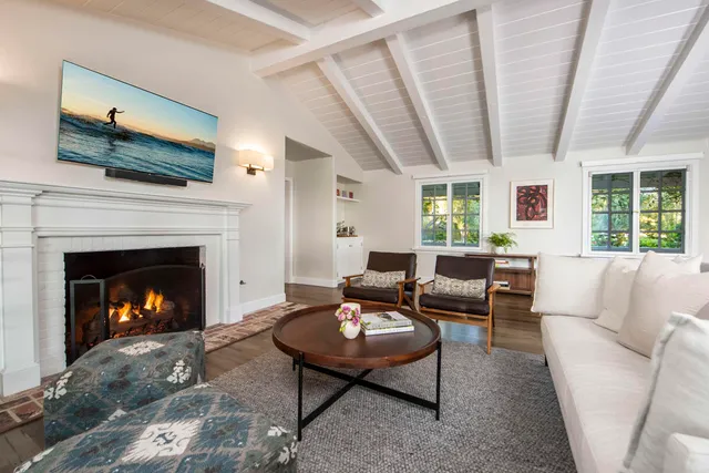 a living room with furniture flat screen tv and a fireplace