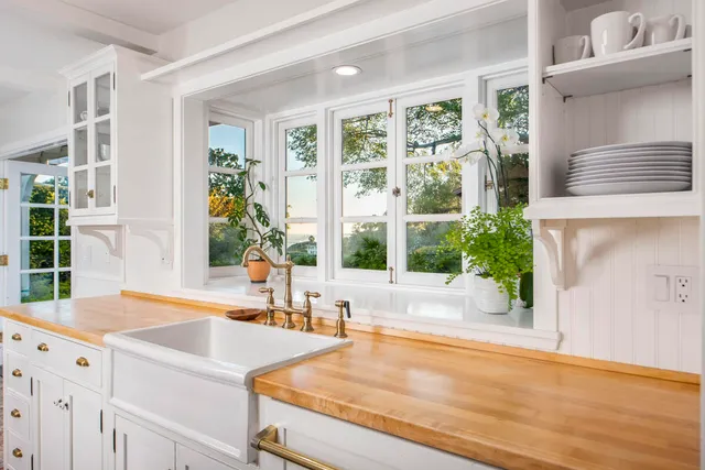 a view of a kitchen with granite countertop a large window and a sink