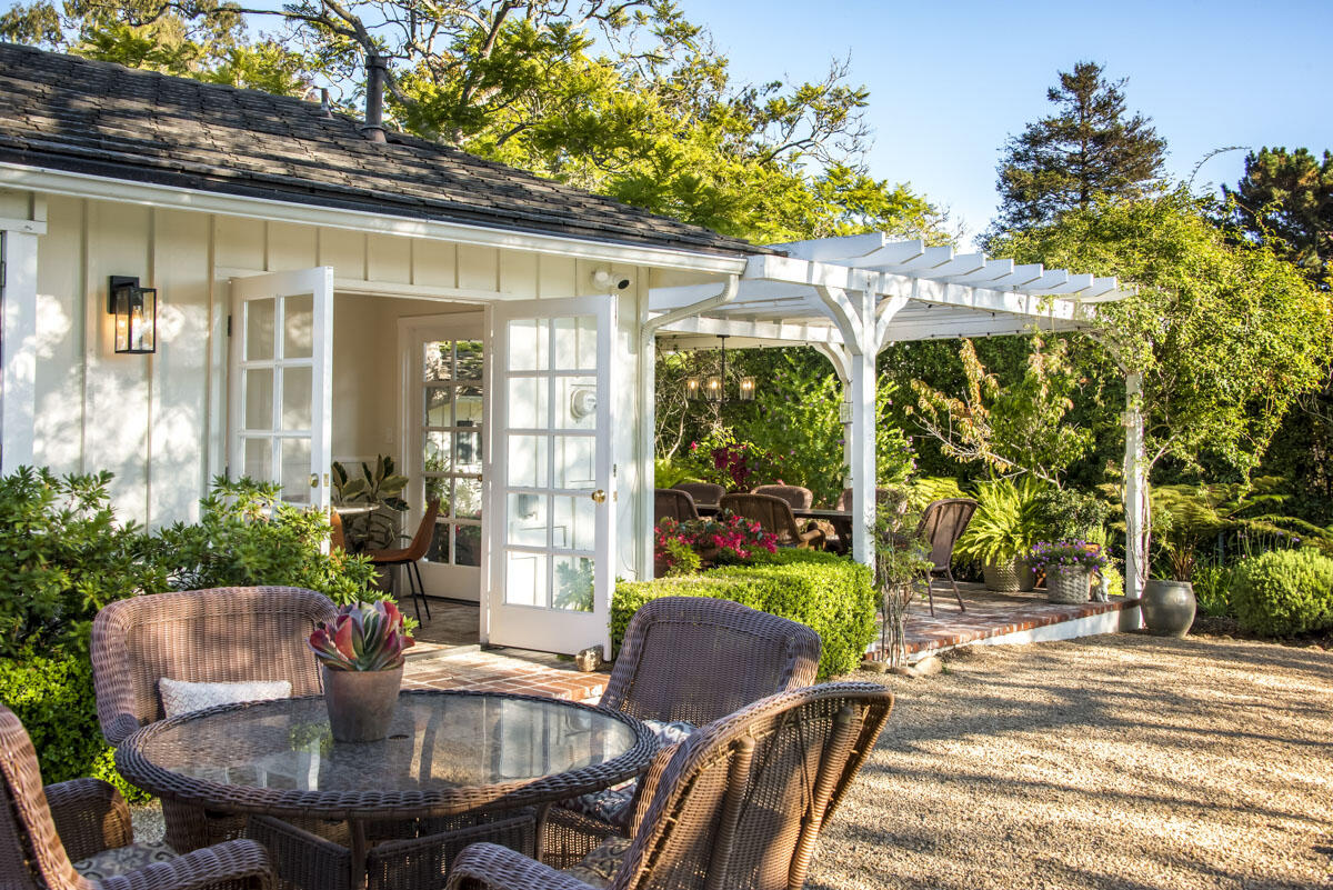223 Rametto Road Santa Barbara, CA 93108 - Photo 19 of 35 a view of a patio with table and chairs potted plants and floor to ceiling window and potted plants