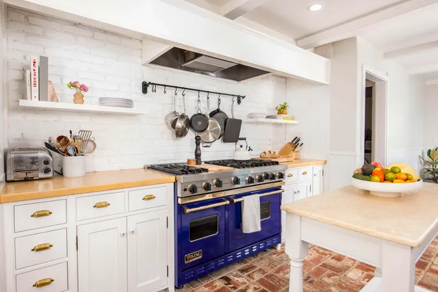 a kitchen with stainless steel appliances a stove and cabinets