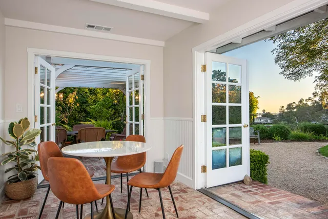 a dining room with furniture and window