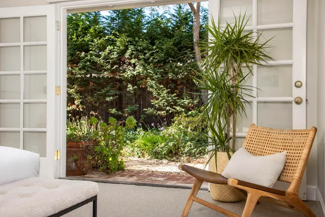 a view of a chair and table in the porch