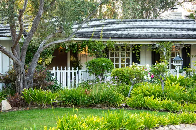 a front view of a house with a garden