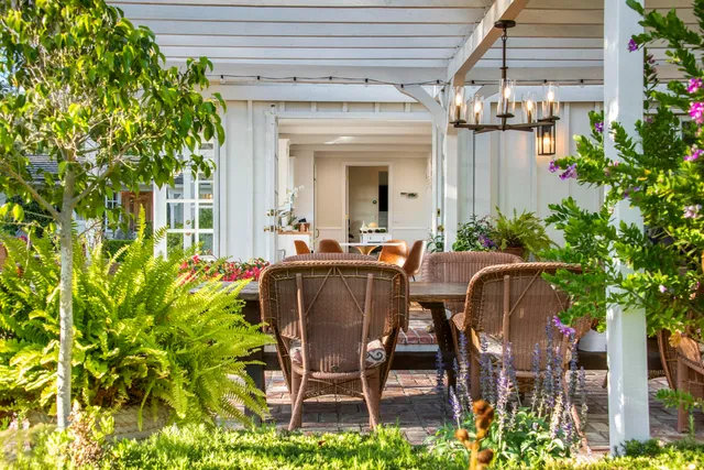 a view of a patio with table and chairs and potted plants