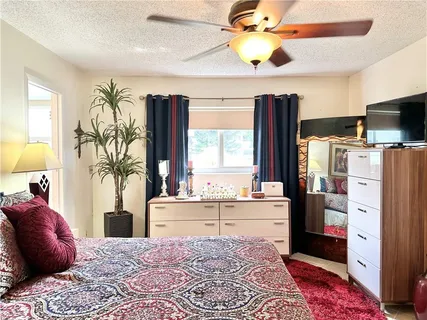 a bed room with a bed and a chandelier