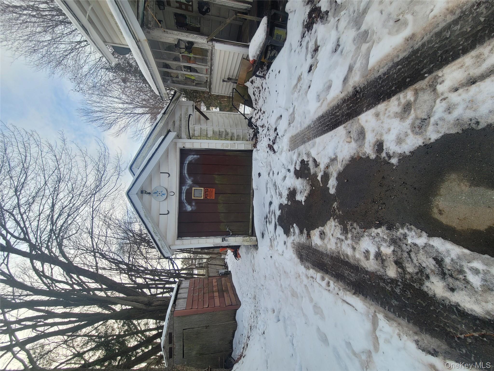 31 South Liberty Road Liberty, NY 12754 - Photo 8 of 8 Snow covered garage with a storage unit and a garage