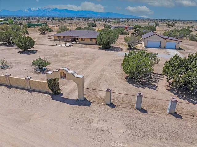 an aerial view of a house with a yard and lake view