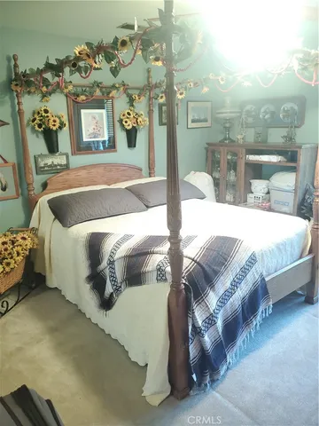 a bedroom with a bed and a mirror