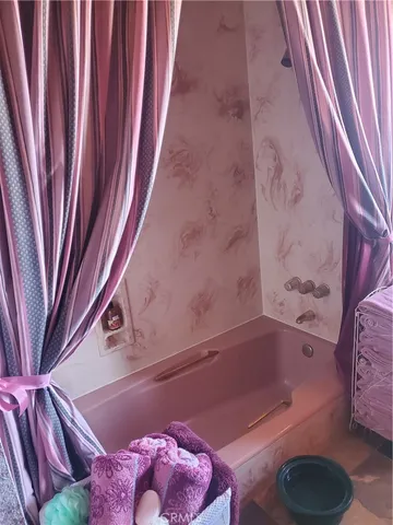 a bathroom with a bathtub and shower