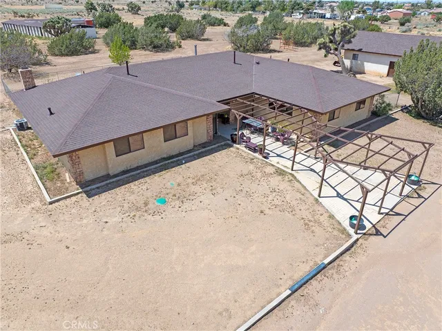 an aerial view of a house with a yard