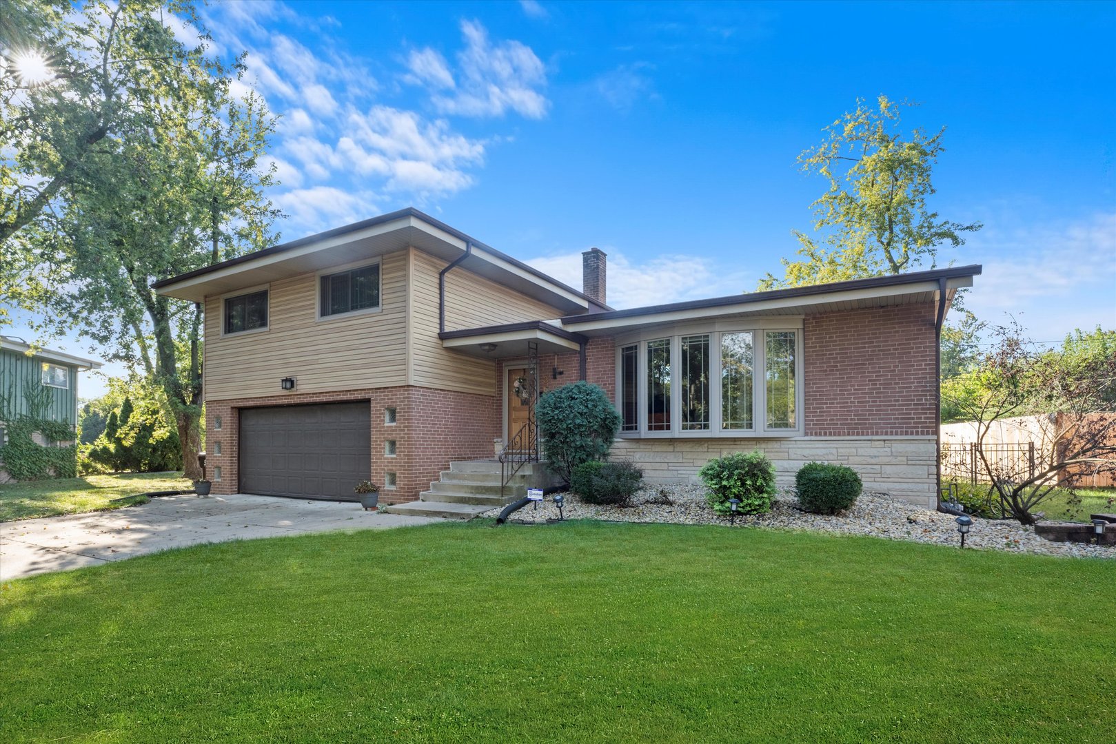3644 Poplar Road Flossmoor, IL 60422 - Photo 2 of 22 a front view of a house with a garden and plants