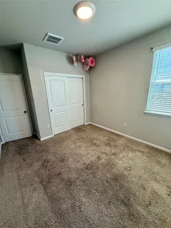 a bed room with a bed and a chair