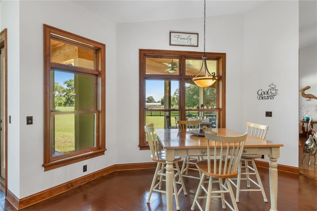 6140 Northwest 145th Avenue Road Morriston, FL 32668 - Photo 12 of 63 a view of a dining room with furniture and windows