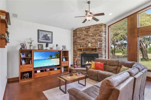 a kitchen with kitchen island granite countertop a sink a counter space appliances and cabinets