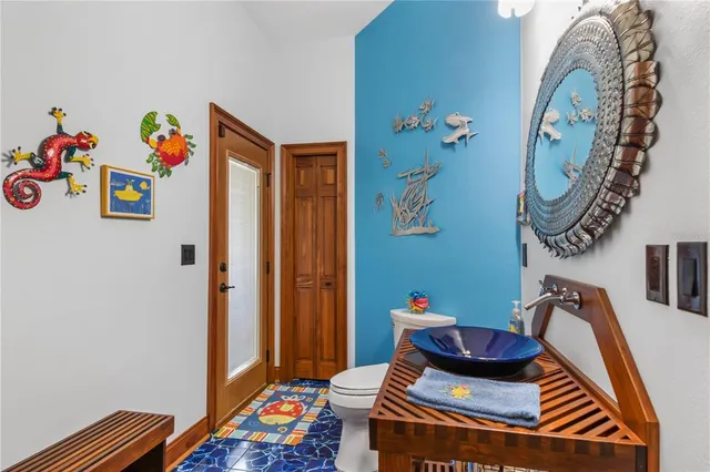 a bedroom with a bed a chandelier and a window