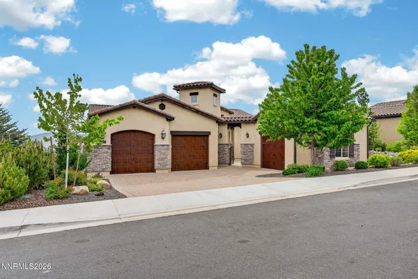 a front view of a house with a yard and garage