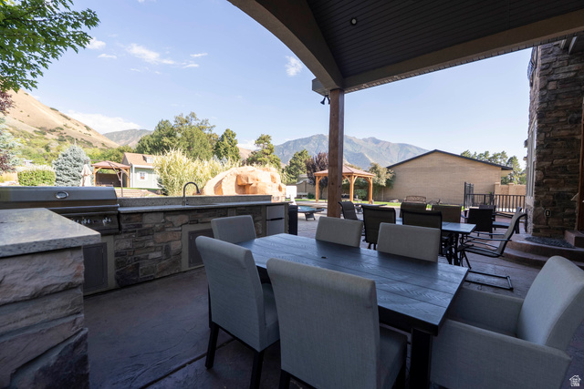 687 South 2080th Street East Springville, UT 84663 - Photo 119 of 149 Covered patio featuring an outdoor kitchen with integrated grill, stone-finish cabinetry, and a countertop sink