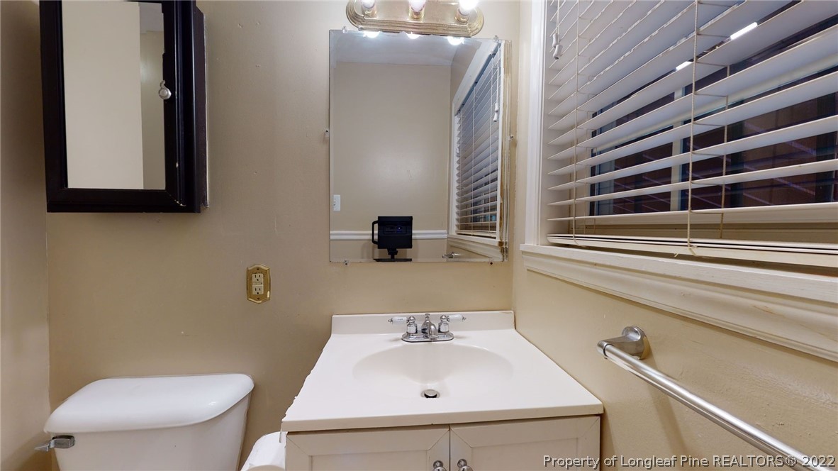 4311 Coventry Road Fayetteville, NC 28304 - Photo 16 of 22 a bathroom with a sink and a toilet