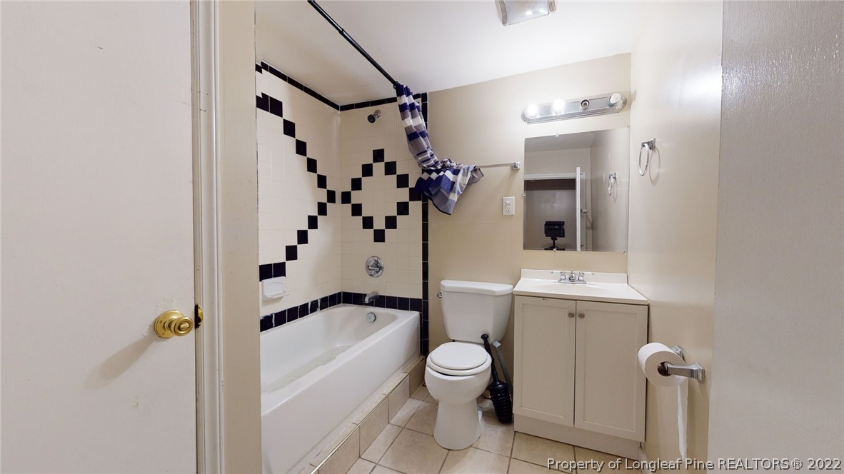 4311 Coventry Road Fayetteville, NC 28304 - Photo 21 of 22 a bathroom with a sink a toilet and shower
