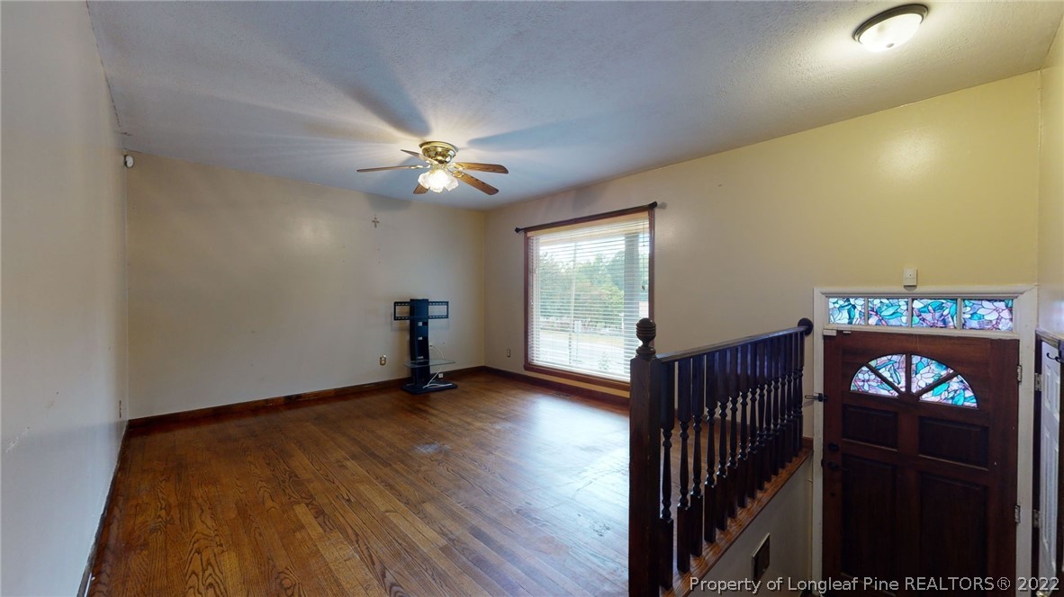4311 Coventry Road Fayetteville, NC 28304 - Photo 5 of 22 wooden floor in an empty room with a window