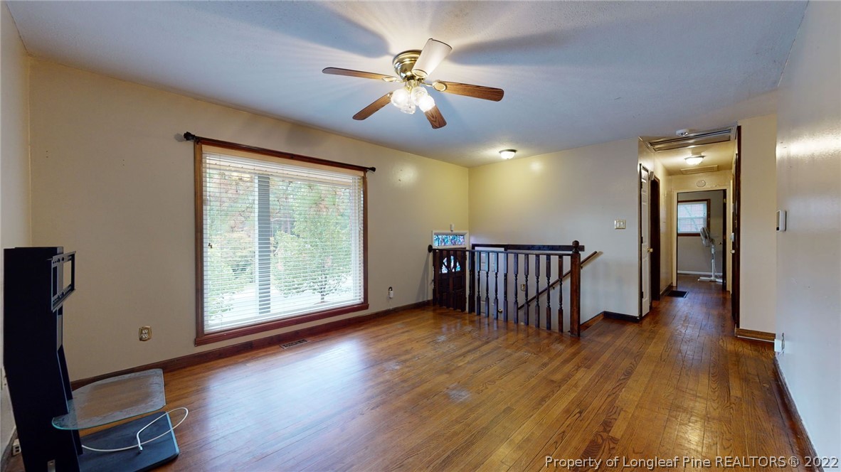 4311 Coventry Road Fayetteville, NC 28304 - Photo 7 of 22 a view of a livingroom with wooden floor and a ceiling fan