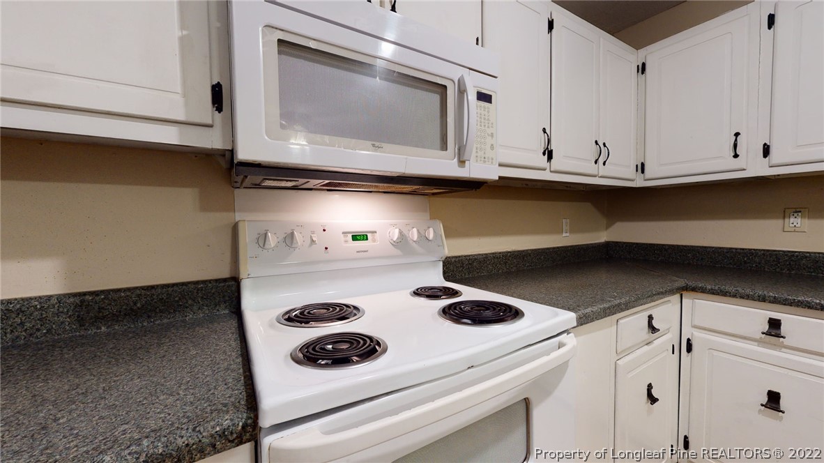4311 Coventry Road Fayetteville, NC 28304 - Photo 10 of 22 a kitchen with a stove and a microwave
