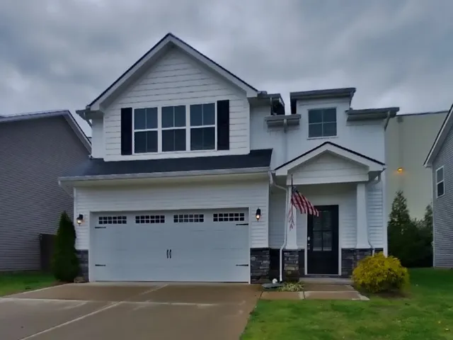 a view of a house with a yard and a large window