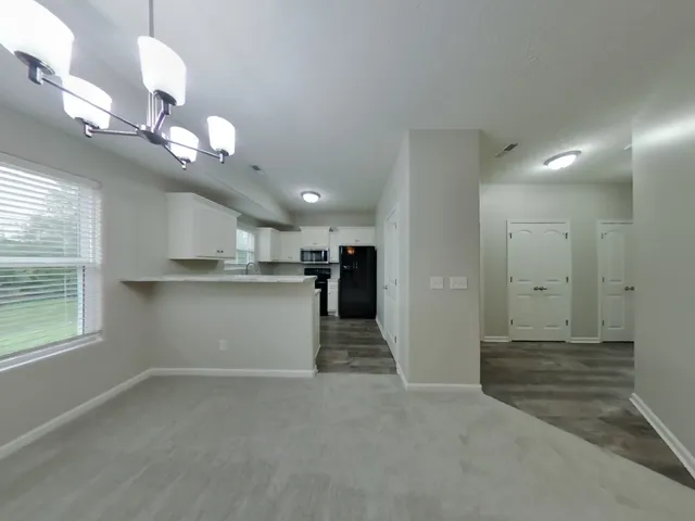 a view of an empty room with a window