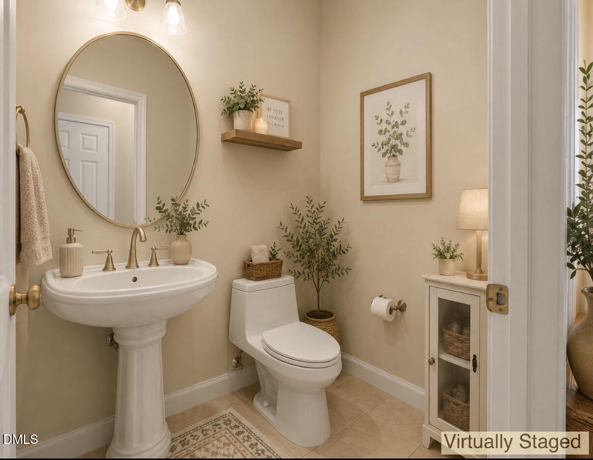 2907 Andover Glen Road Raleigh, NC 27604 - Photo 10 of 39 a bathroom with a toilet sink and mirror