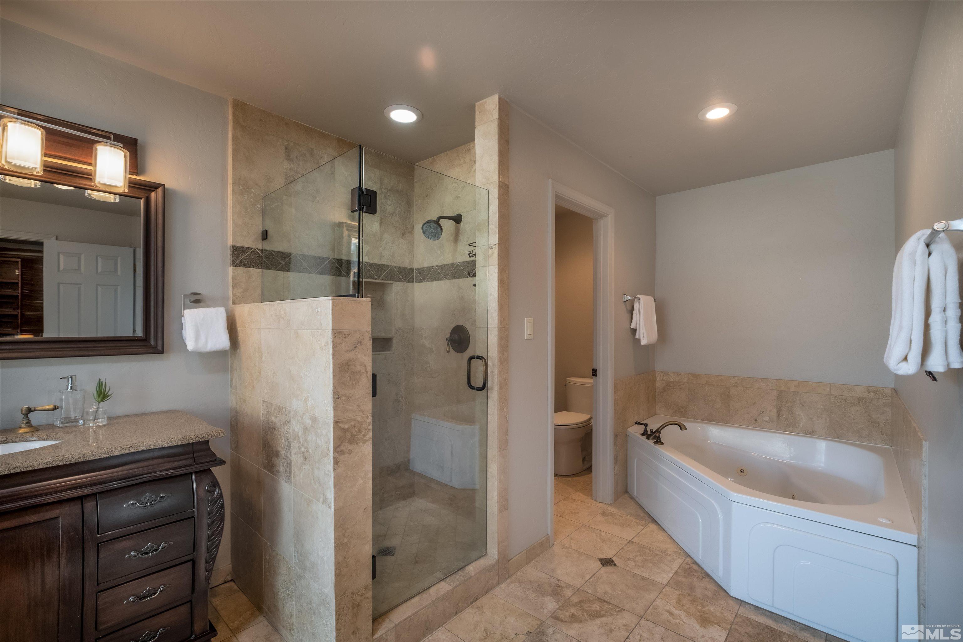 1940 View Reno, NV 89511 - Photo 16 of 38 a bathroom with a tub sink shower and mirror
