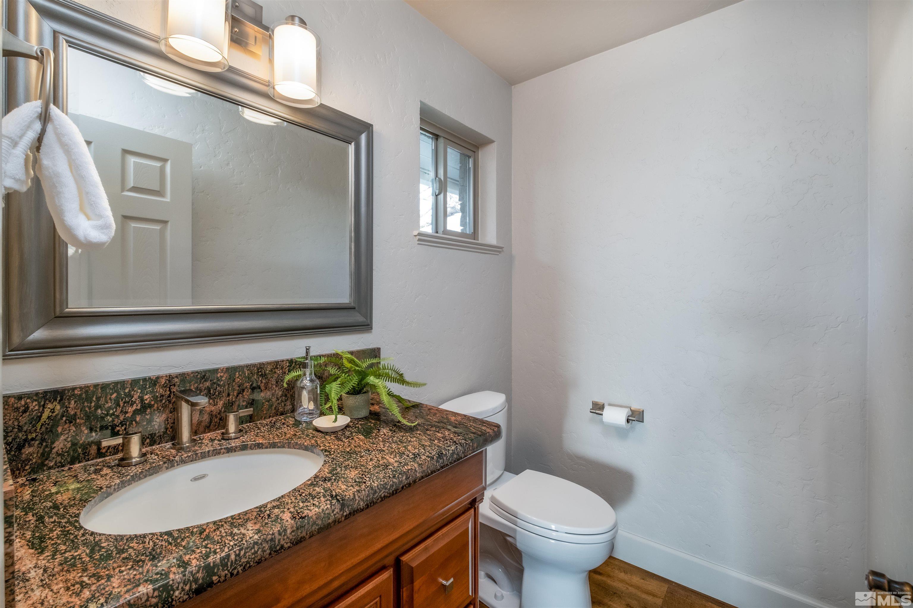 1940 View Reno, NV 89511 - Photo 22 of 38 a bathroom with a granite countertop sink and a mirror