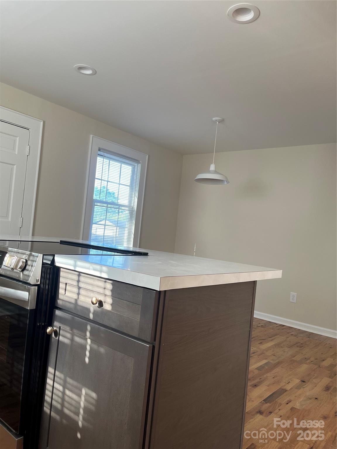 60 3rd Street Concord, NC 28025 - Photo 3 of 10 a room with a sink cabinets and wooden floor